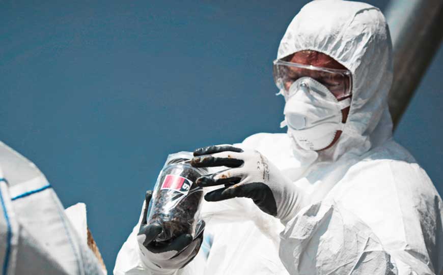 Surveyor taking a sample of asbestos paint